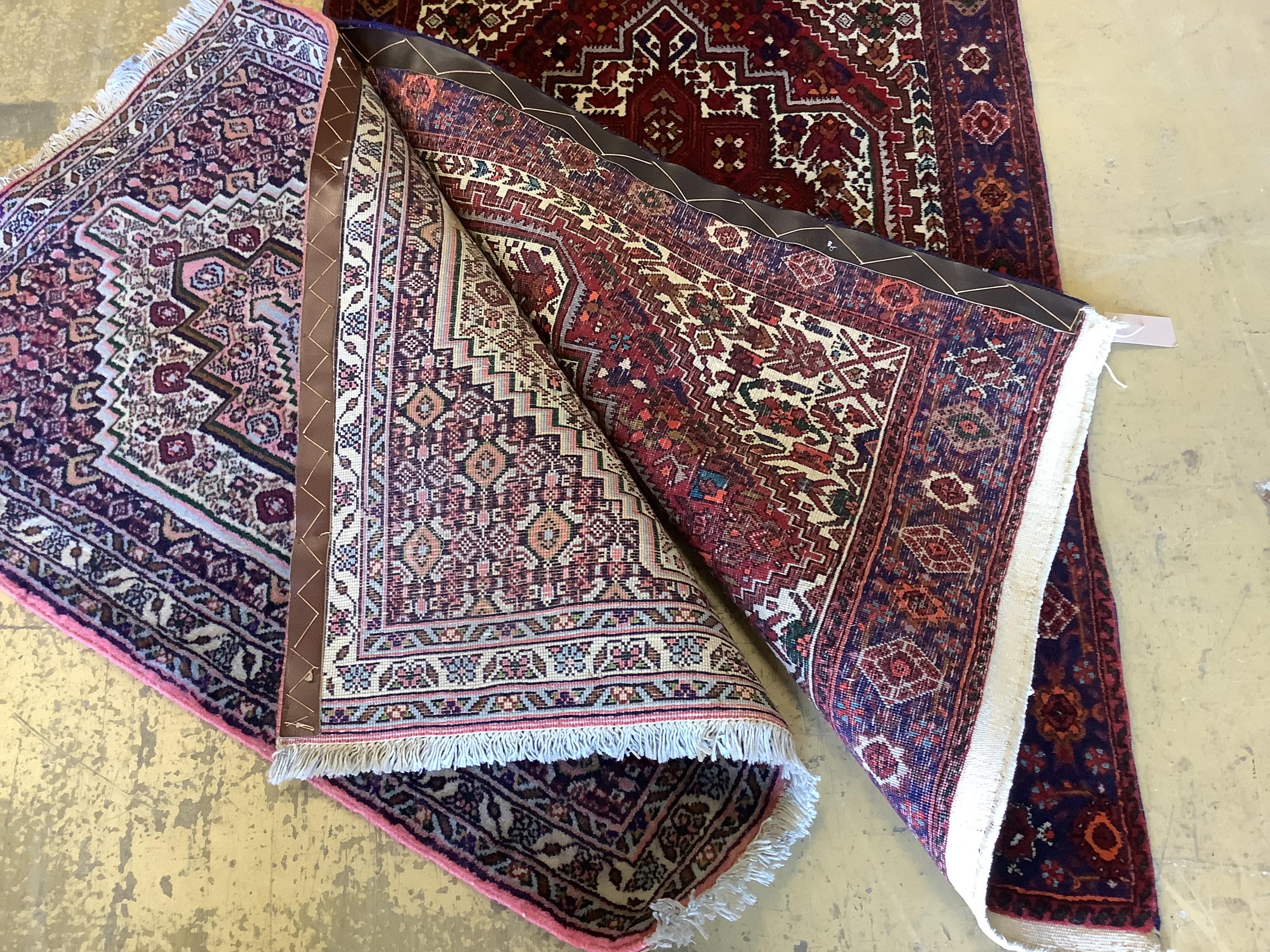 Two Senneh red ground mats, larger 130 x 80cm